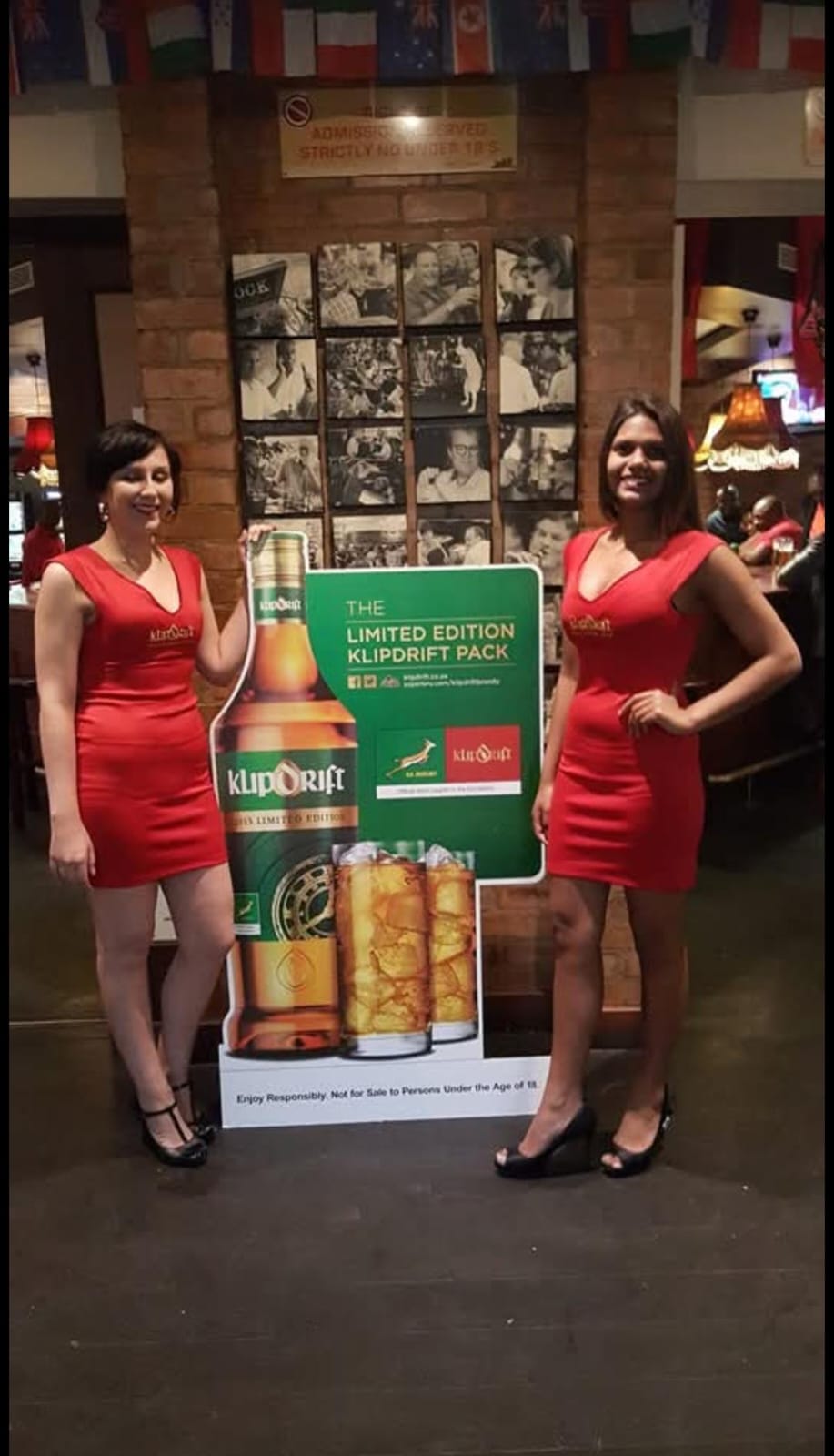 Klipdrift promoters beside a branded display in a pub
