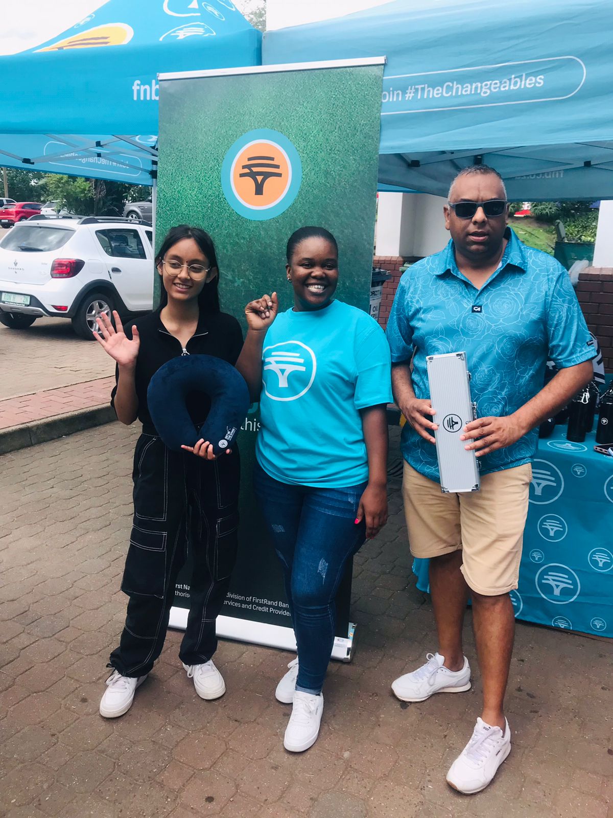 FNB activation team handing out branded giveaways to customers at a forecourt